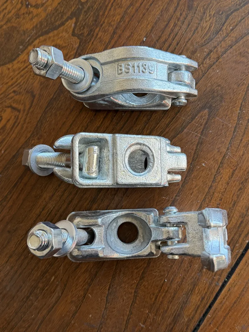Three forged scaffold coupler parts shown side by side