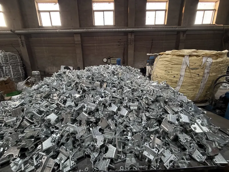 Large heap of galvanised forged coupler parts on the factory floor