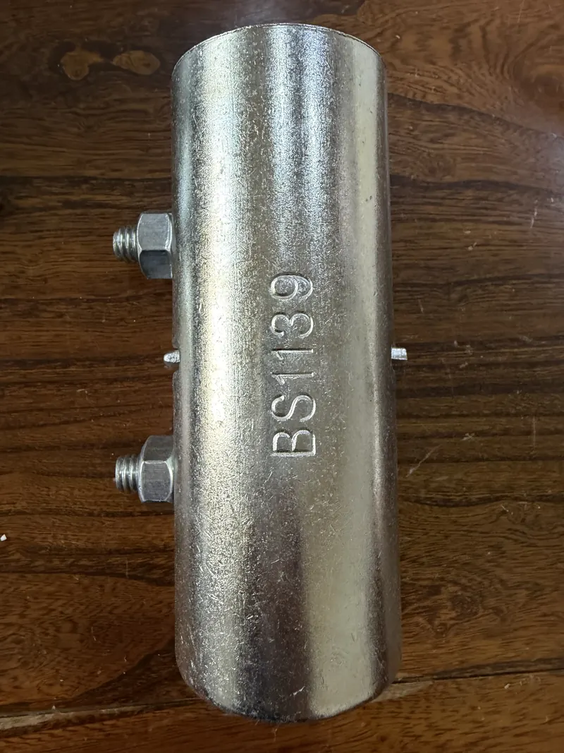 Galvanised scaffold sleeve coupler marked BS1139 with two bolts