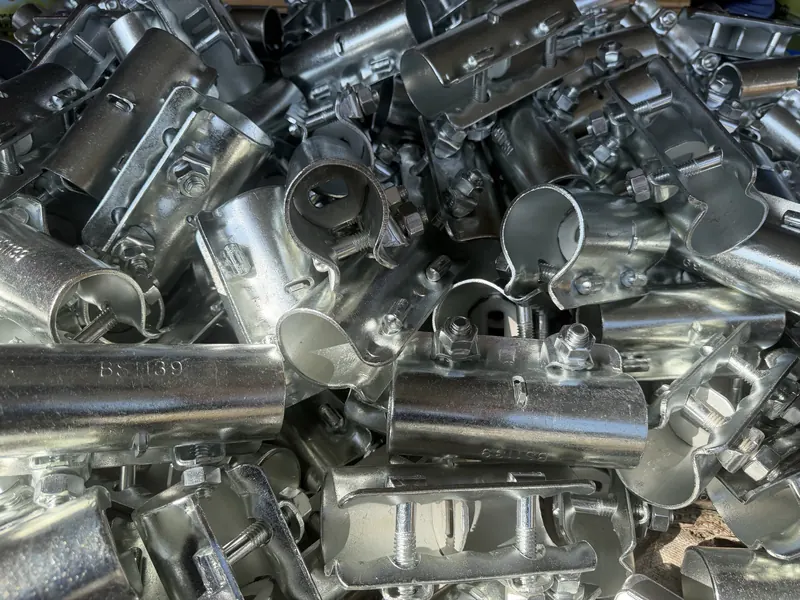 Galvanised sleeve couplers and other fittings in a heap